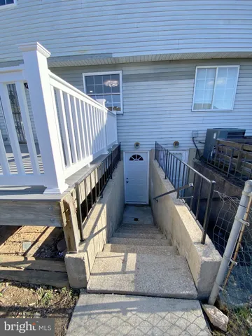 a view of entryway kitchen and hall with wooden floor
