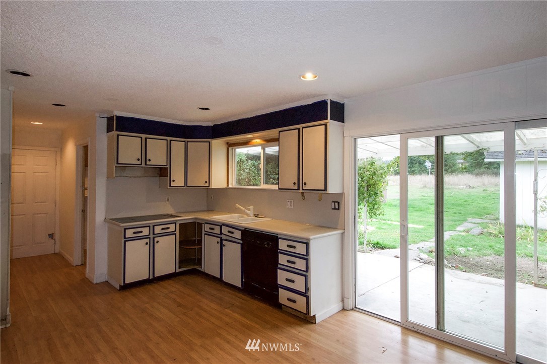 190 Roupe Road Sequim, WA 98382 - Photo 5 of 20 a view of a kitchen with stainless steel appliances granite countertop a stove and a large window