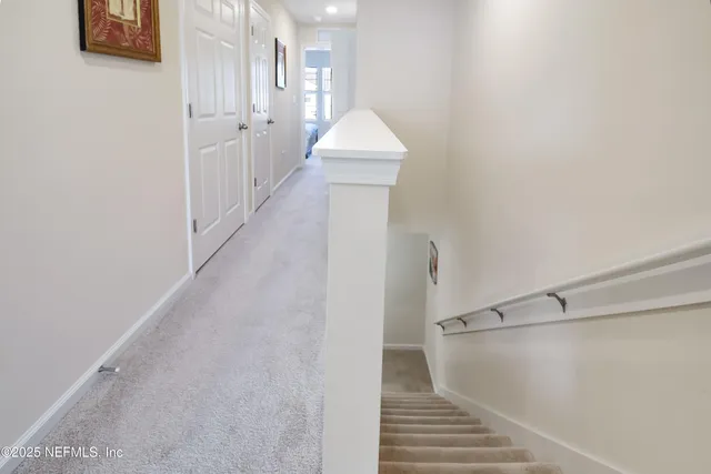 a view of a hallway view with staircase