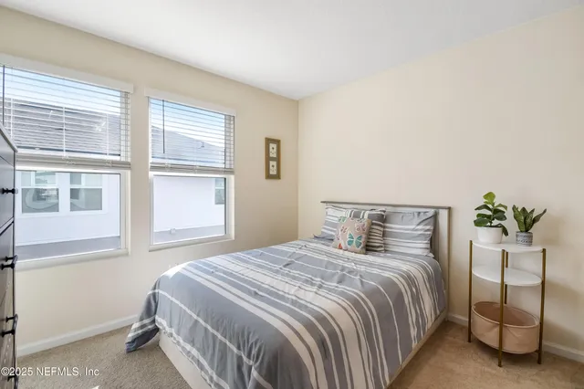 a bedroom with a bed and window