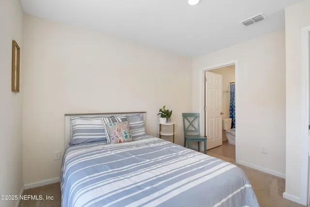 a bedroom with a bed and a mirror