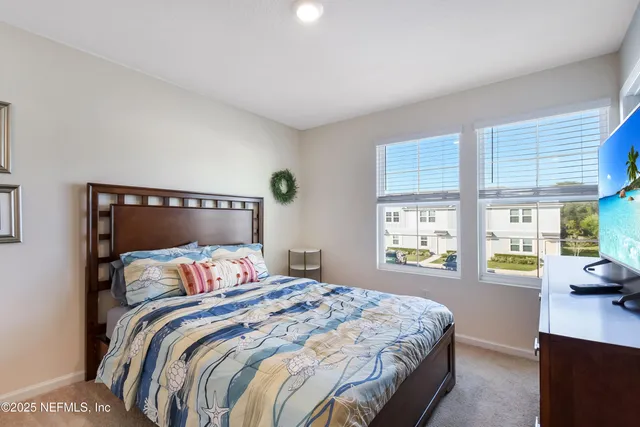 a bedroom with a large bed and a large window