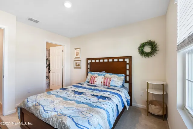 a bedroom with a bed and mirror