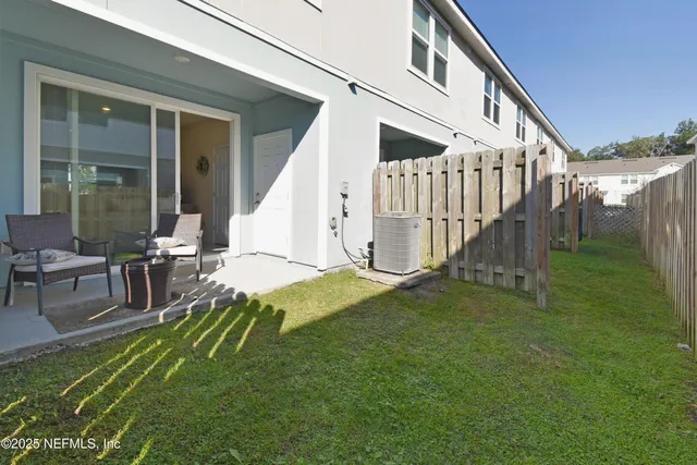 a view of house with backyard and outdoor seating