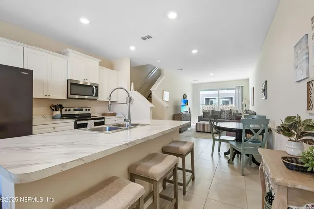 a large kitchen with lots of counter space and stainless steel appliances