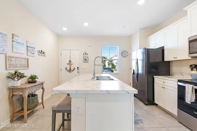 a kitchen with a sink a refrigerator and a stove