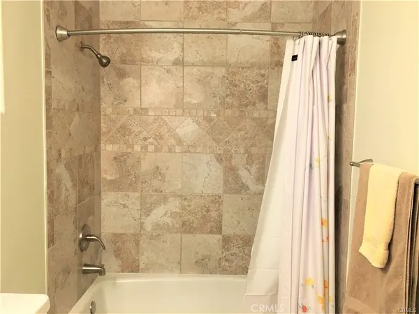 a bathroom with a shower and a tub