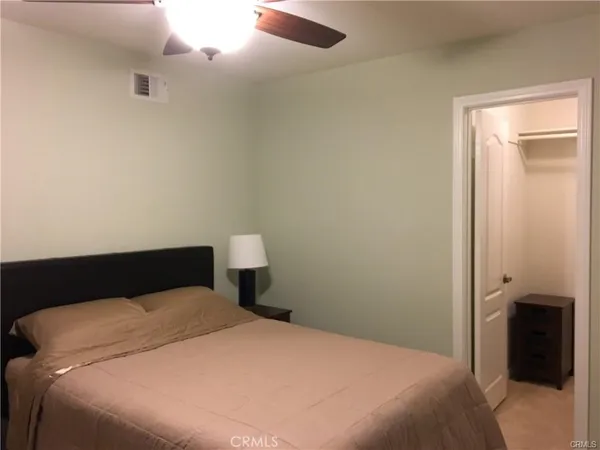 a bedroom with a bed and a walk in closet