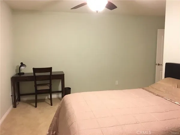 a bedroom with a bed and a table