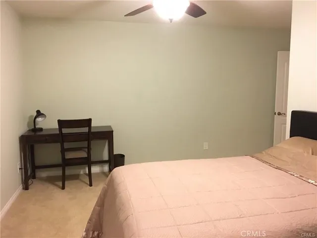 a bedroom with a bed and a table
