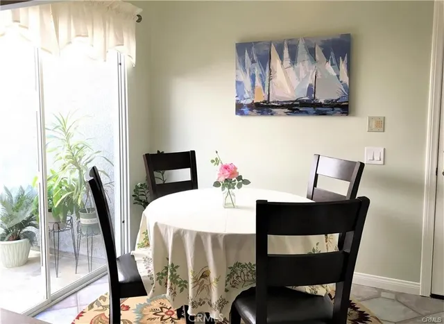 a dining room with furniture and window