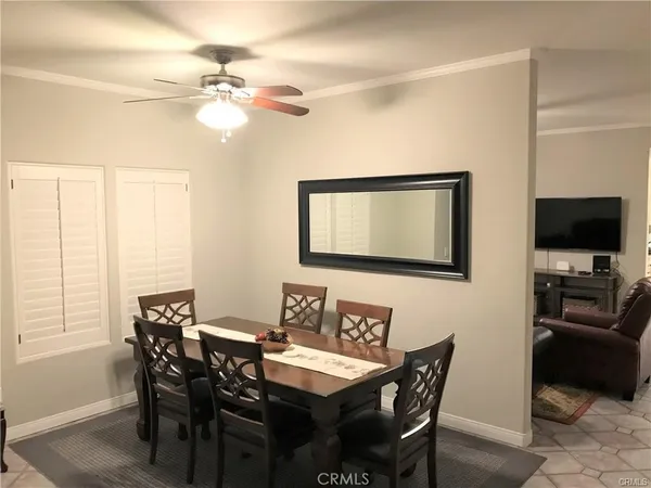 a view of a dining room with furniture and a chandelier
