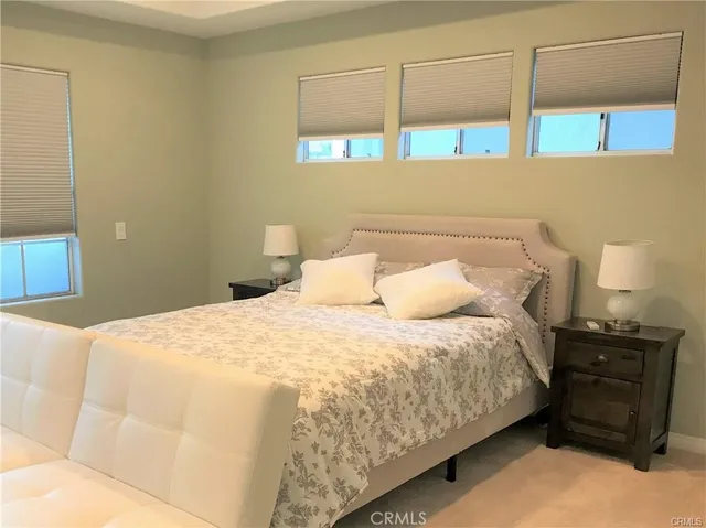 a bedroom with a bed and a night stand