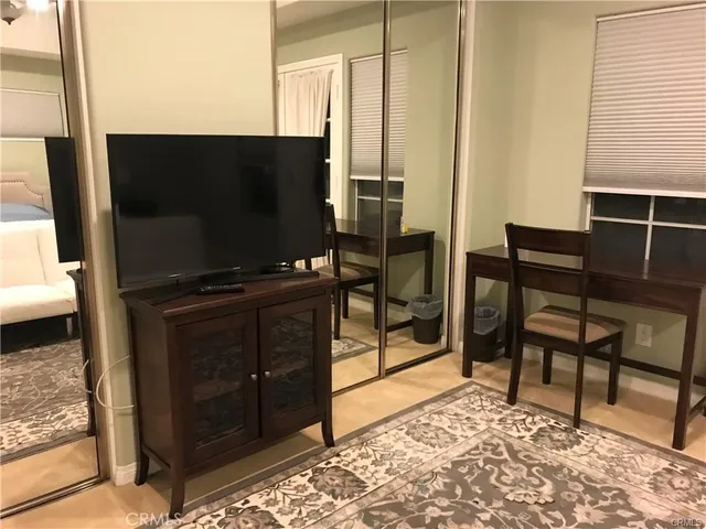 a living room with chair and a flat screen tv