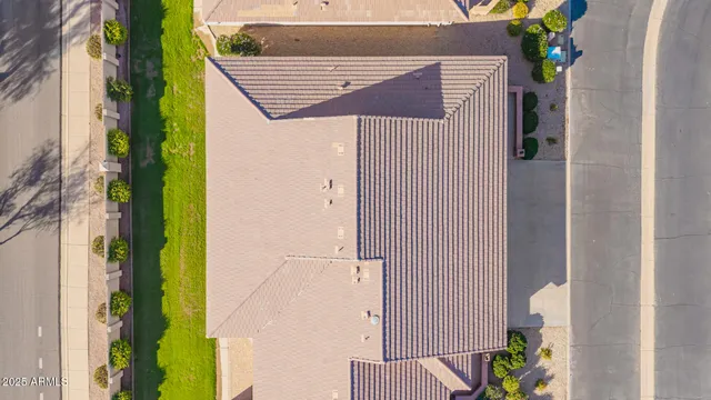 an aerial view of a house with a yard and lake view