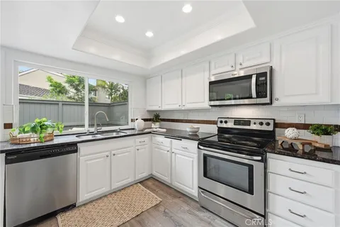 a kitchen with a sink stove and microwave