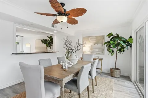 a view of a dining room with furniture and a potted plant