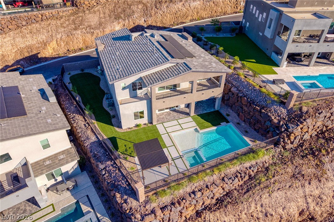 526 Riley Ridge Henderson, NV 89012 - Photo 2 of 10 Perched on a hillside, this contemporary residence features a sparkling pool and inviting outdoor living spaces.