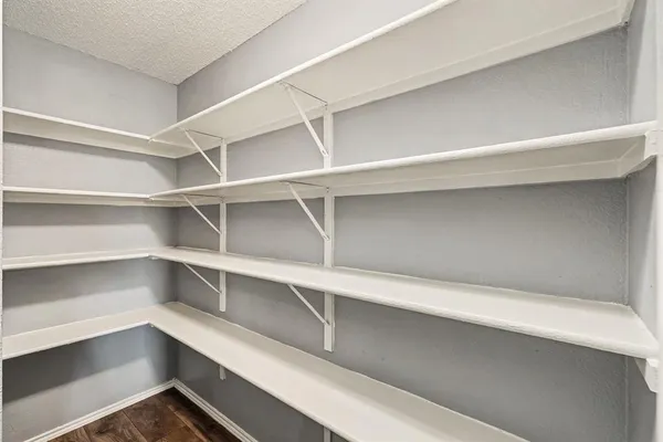 a view of walk in closet with empty racks
