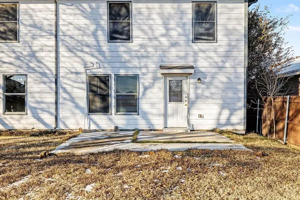 a view of a brick house with many windows