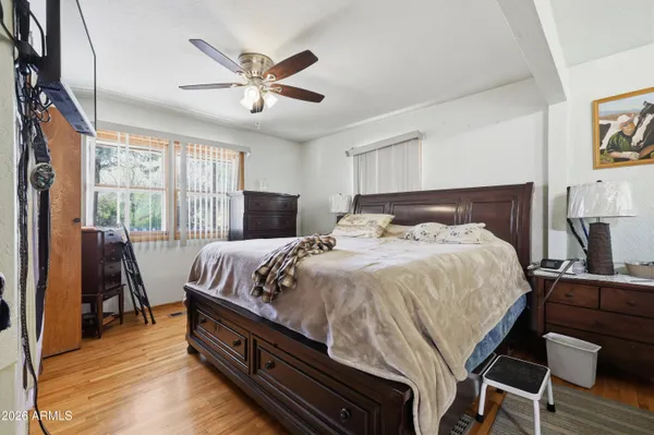 a bedroom with a bed and wooden floor