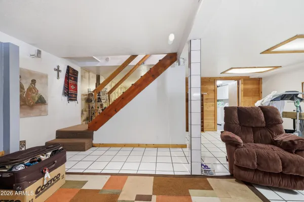 a living room with patio furniture and a flat screen tv