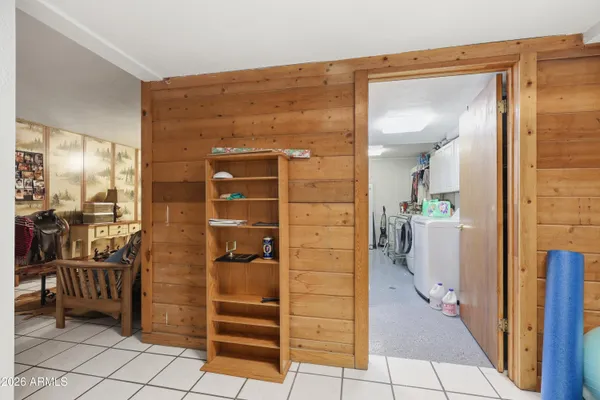 a bedroom with furniture and a large window