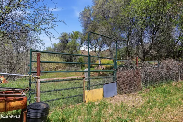 a view of a chair and table in backyard of the house