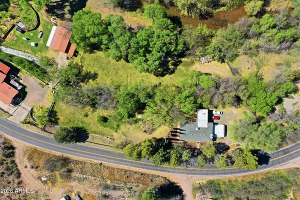 an aerial view of a house with a yard and garden