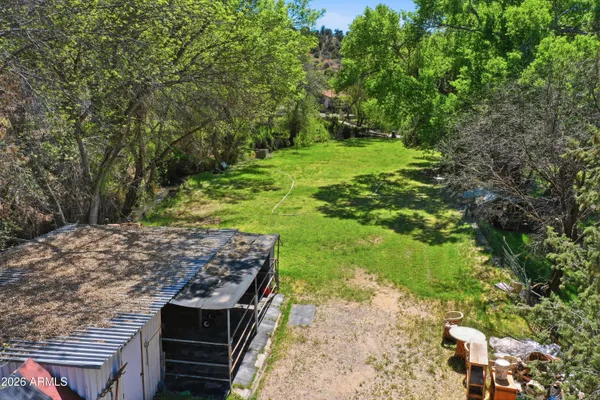 a view of a wooden dinning table and chairs in the patio