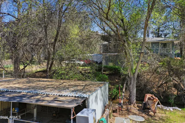 a view of a chairs and fire pit in the yard