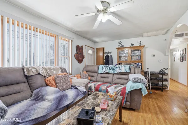 a living room with furniture and wooden floor