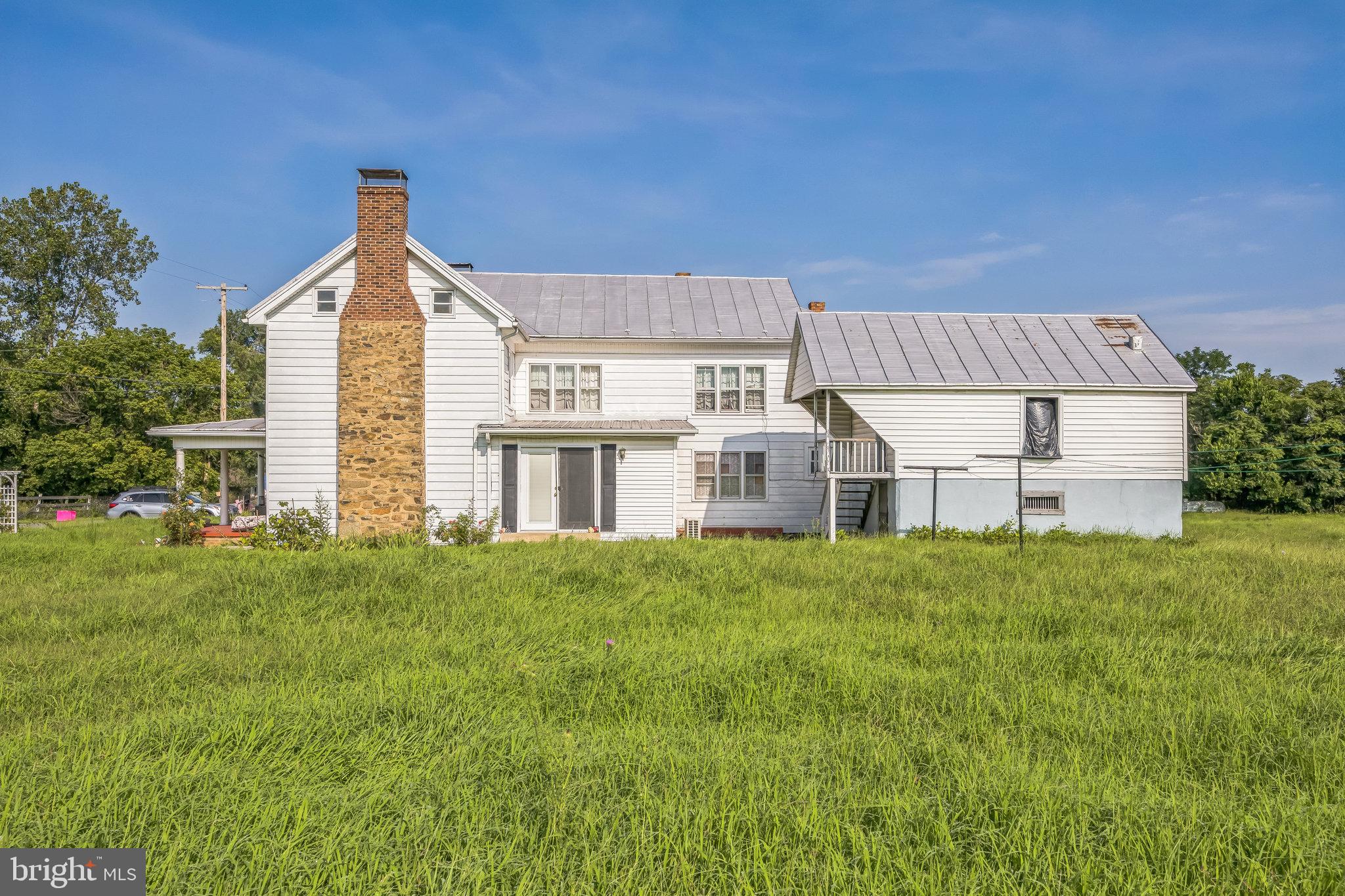 221 Kite Hollow Road Stanley, VA 22851 - Photo 2 of 33 Charming farmhouse nestled in lush greenery.