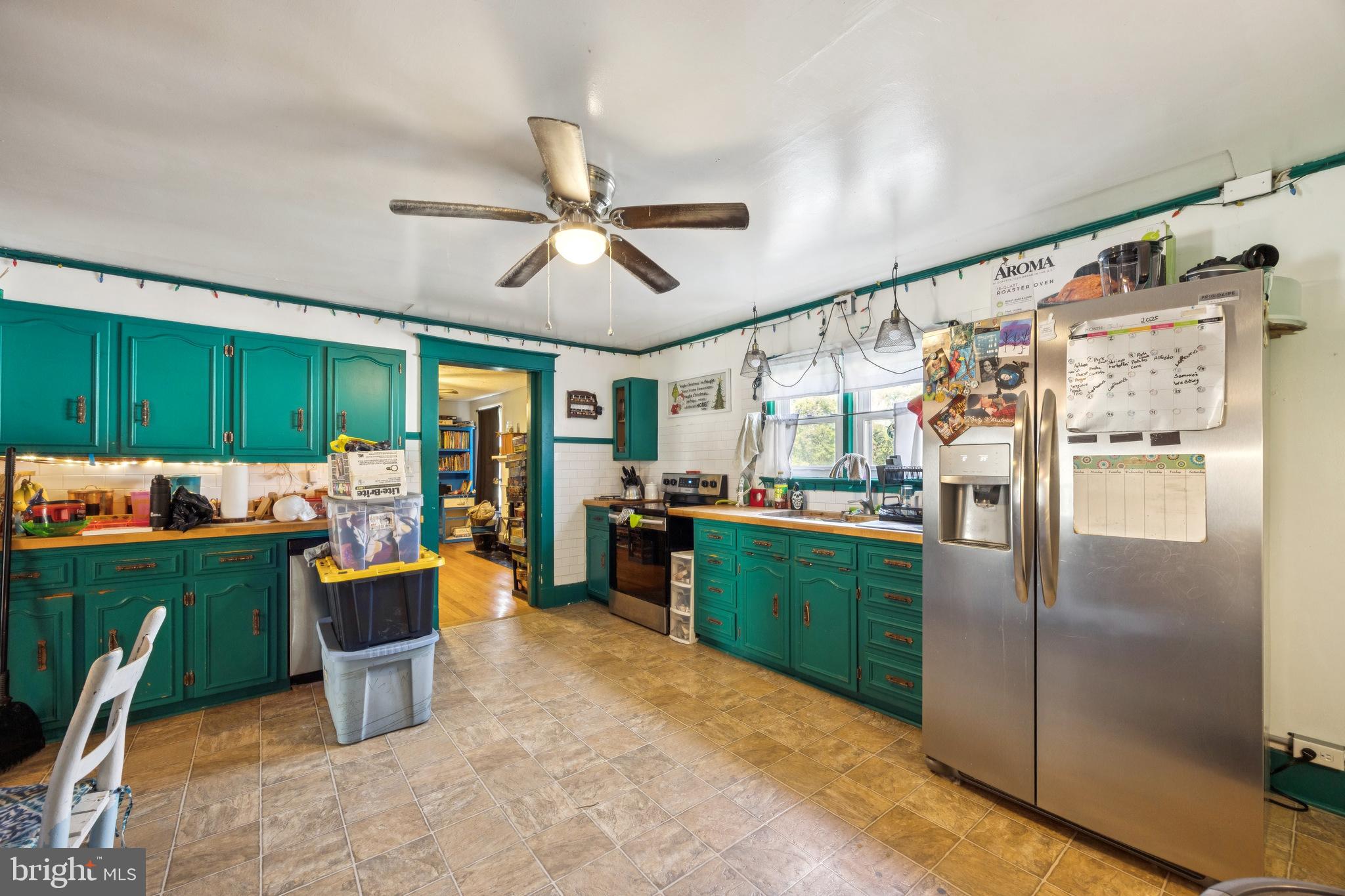 221 Kite Hollow Road Stanley, VA 22851 - Photo 7 of 33 Vibrant kitchen with teal cabinetry charm.