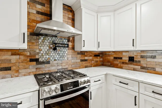 a white stove top oven sitting inside of a kitchen