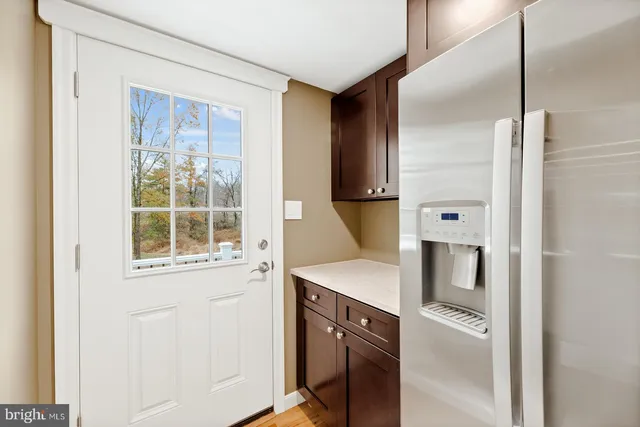 a kitchen with a refrigerator and a sink