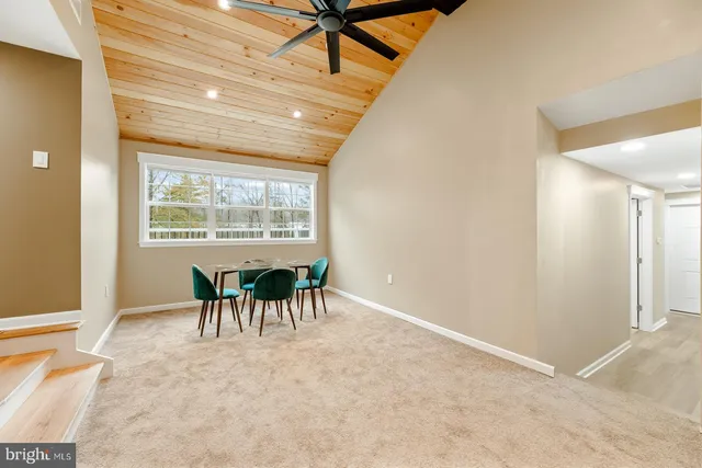 a dining room with furniture and a chandelier