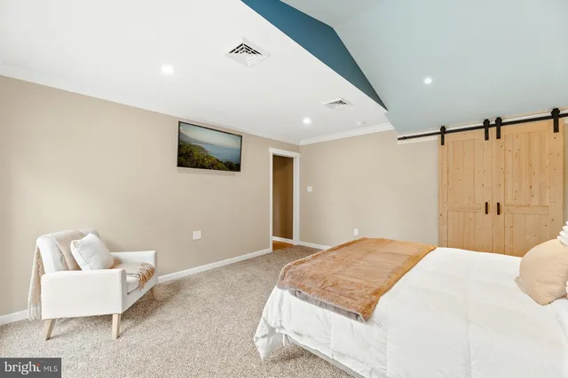 a bedroom with a bed and a couch