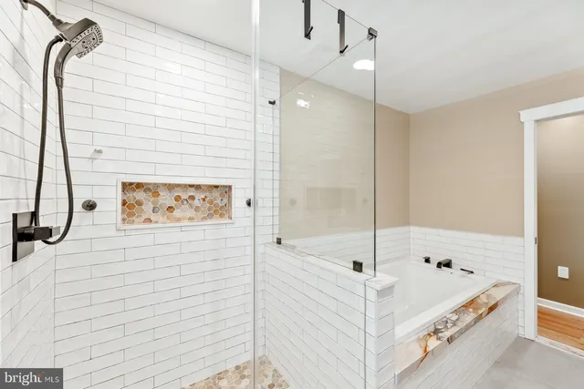 a bathroom with a bathtub and a shower