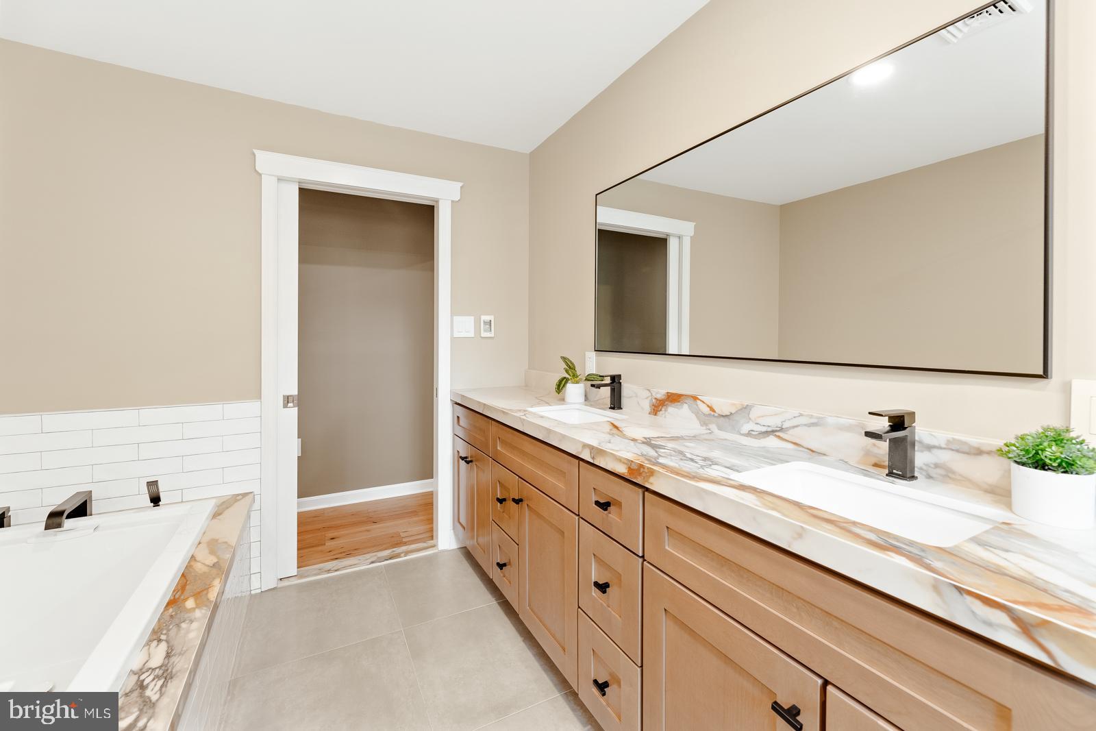 4448 Lower Mountain Road New Hope, PA 18938 - Photo 29 of 49 a bathroom with a double vanity sink and a bathtub