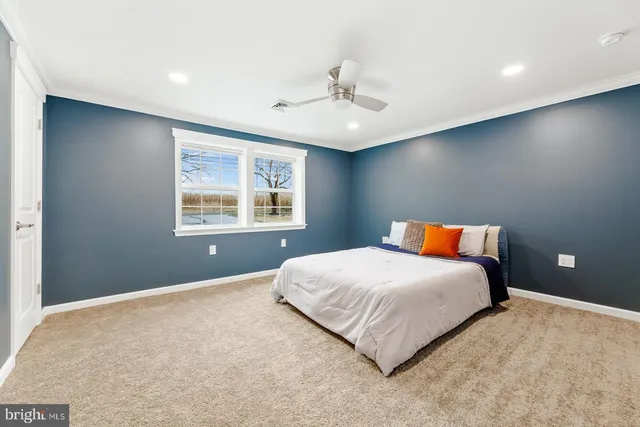 a bedroom with a large bed and a window