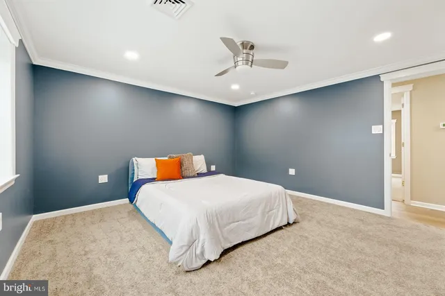 a bedroom with a large bed and a chandelier