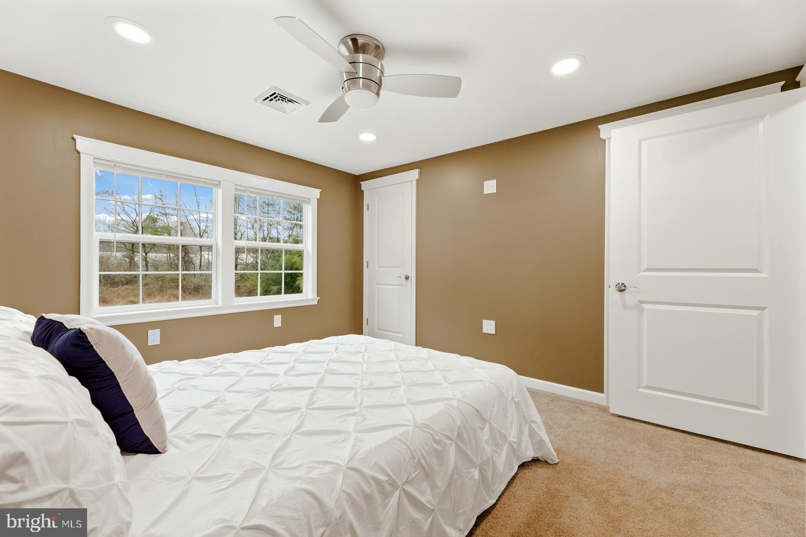 4448 Lower Mountain Road New Hope, PA 18938 - Photo 34 of 49 a spacious bedroom with a large bed and a chandelier