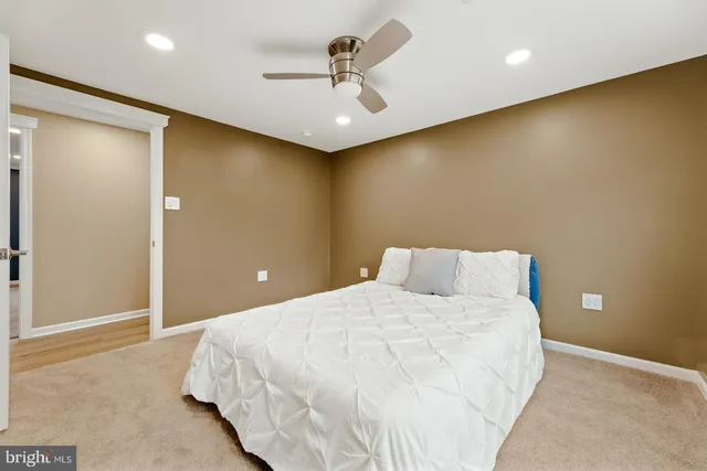 a bedroom with a bed and a ceiling fan