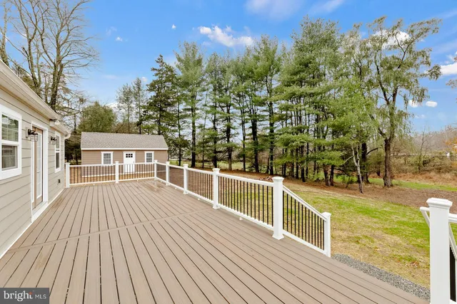 a view of a balcony with wooden floor and fence