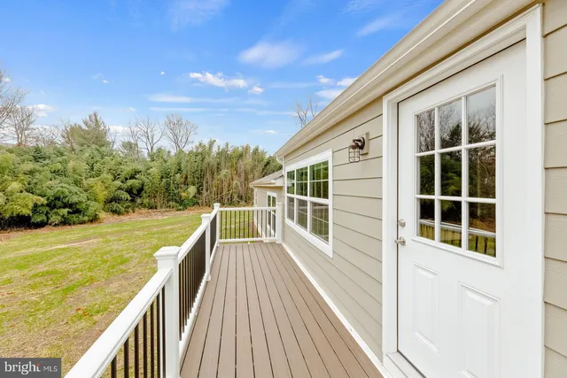 a view of a balcony with mountain view and wooden floor