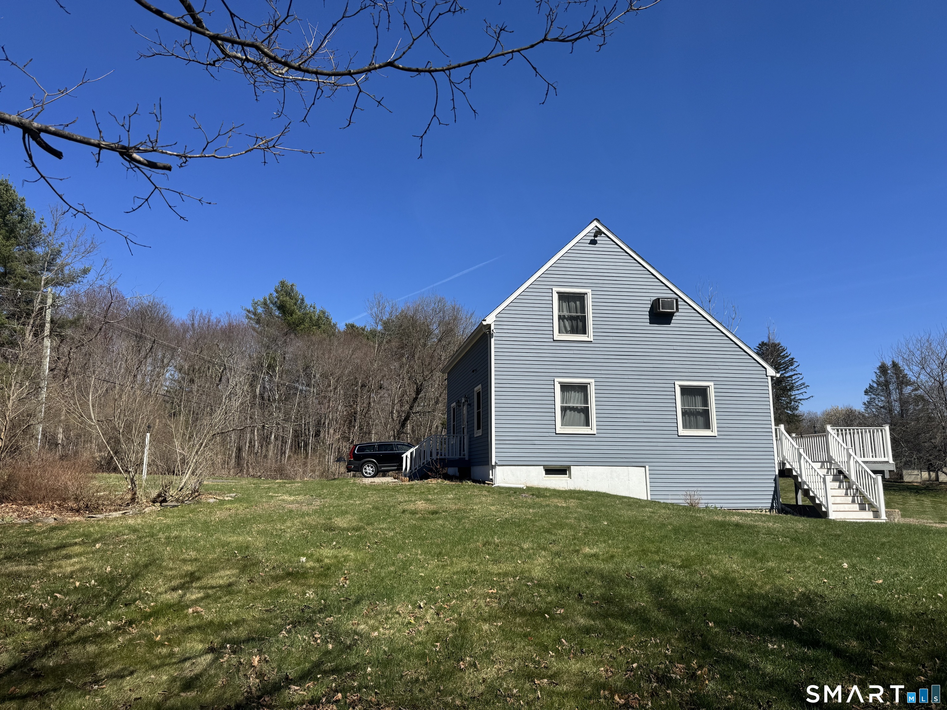 103 Birch Road Mansfield, CT 06268 - Photo 5 of 46 a front view of a house with a yard