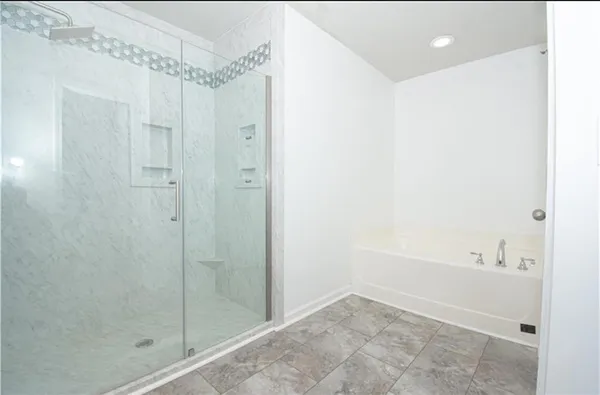 a bathroom with a shower and a bath tub