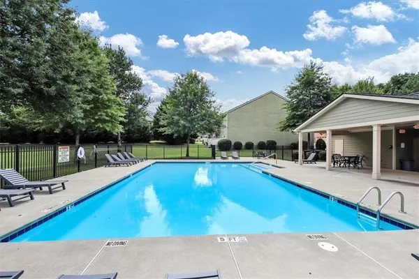 a view of a house with swimming pool and sitting area