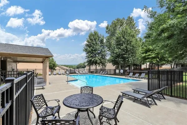 a view of a backyard and swimming pool